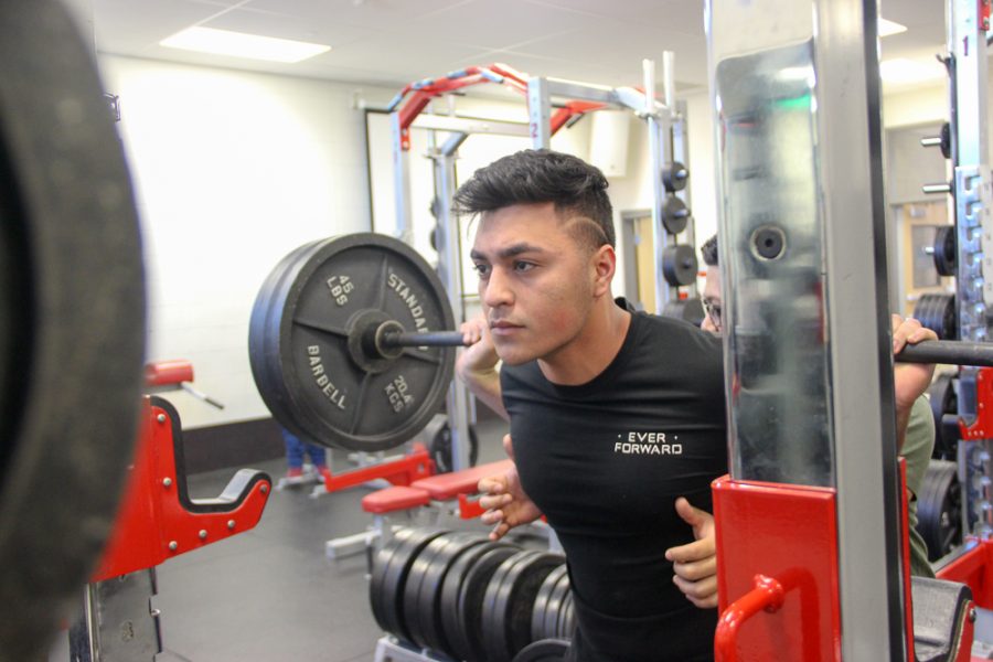 Christopher Lopez lifts while Züng Thāng spots him for safety.