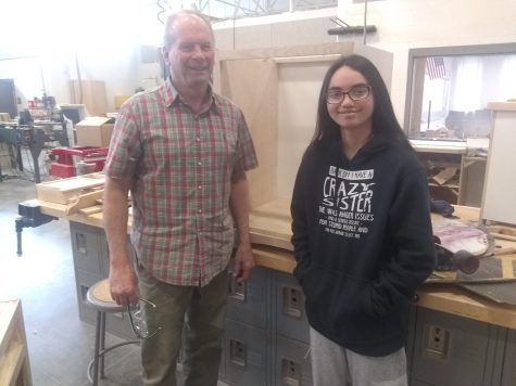 Mr. Masimer teaches woodworking, and Alia is enjoying his class.