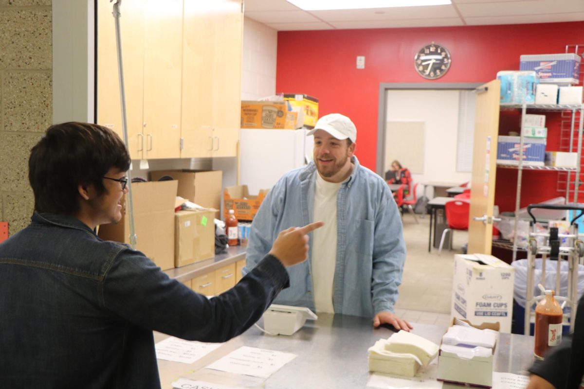 Mr. Ballou is the latest retailing teacher in charge of the schools G-Store.