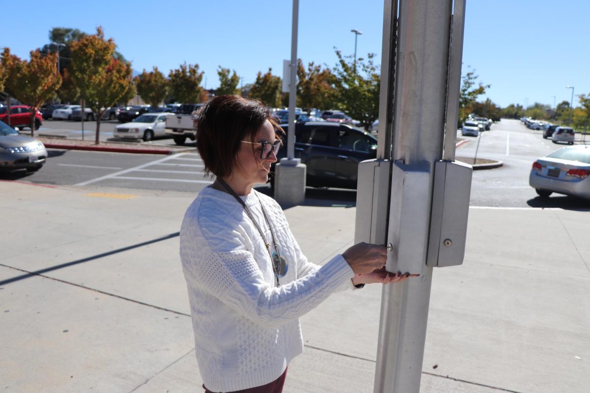  Ms. McMillan opens the flagpole’s Yonder pouch unlocking station