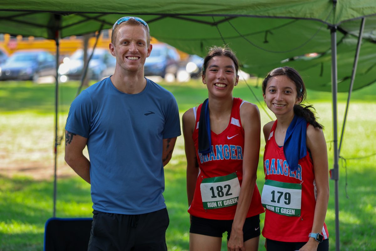Coach Rice congratulates Trineris and Zurisadai after a 5K race. (PC: John Barkiple/stringer)